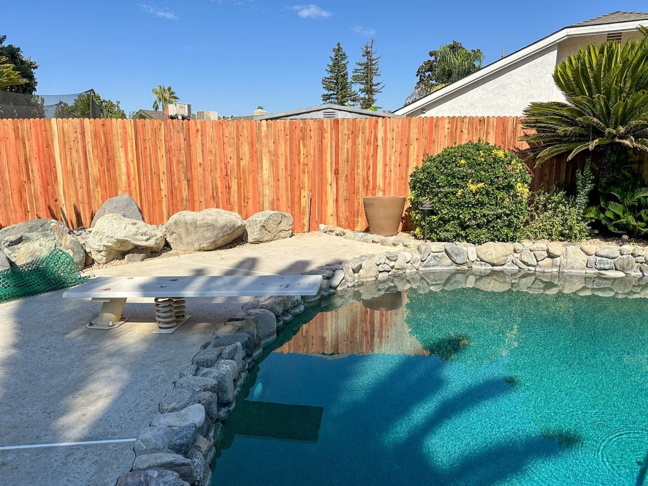 Wood privacy fence beside a backyard pool in Bakersfield