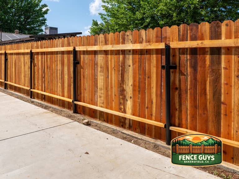 Inside view of a wood and metal sliding gate beside a matching fence line