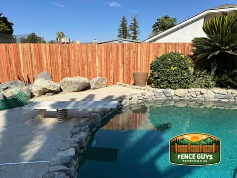 Bakersfield wood fence installation around a backyard pool